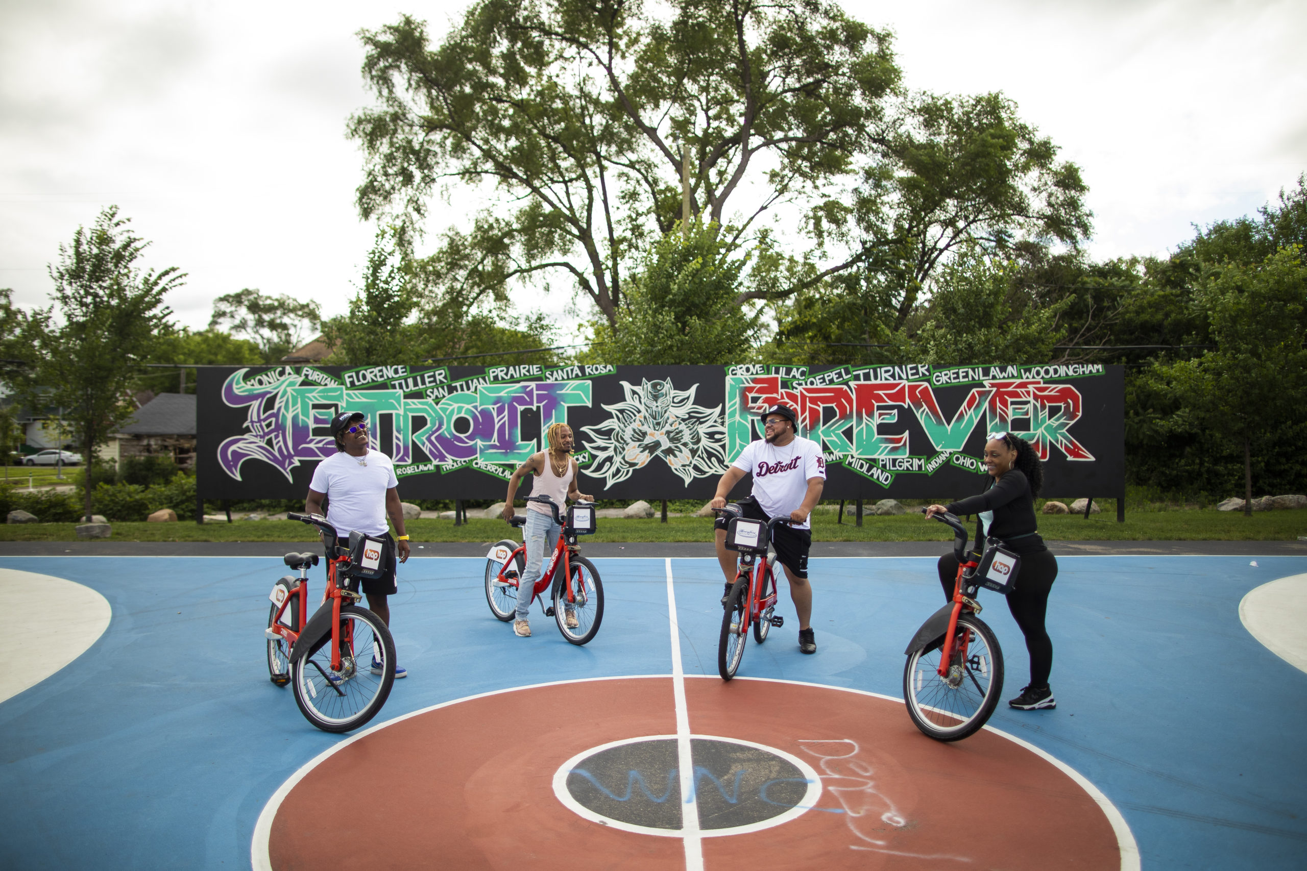 MoGo riders pose in front of a mural at Ella Fitzgerald Park in Northwest Detroit.